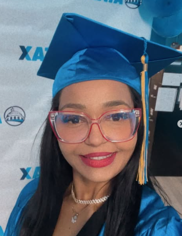 A person wearing a blue graduation cap and gown